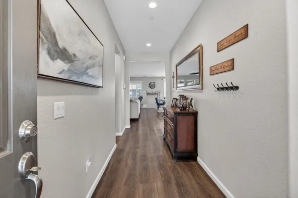 a view of a hallway with wooden floor and workspace