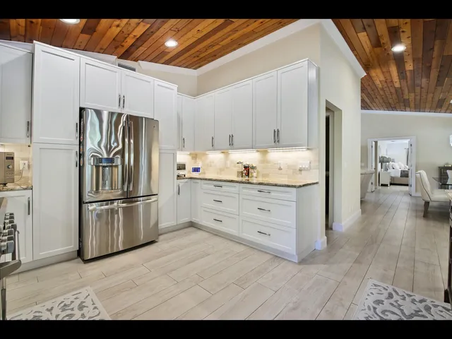 a kitchen with a refrigerator and cabinets