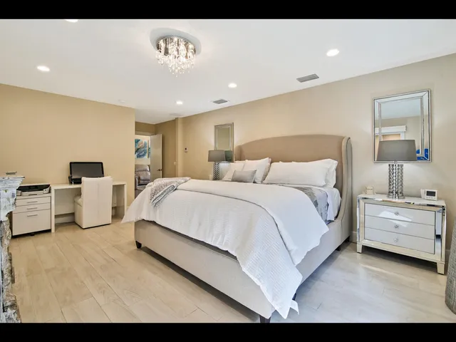 a spacious bedroom with a bed and a couch