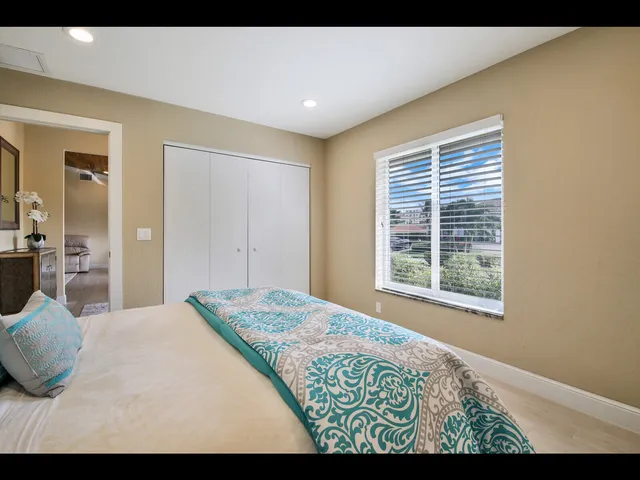 a view of a bedroom with wooden floor and a window