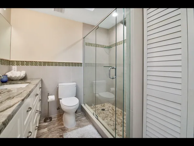 a bathroom with a toilet and a shower