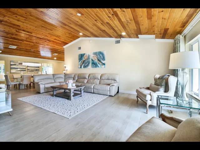 a living room with furniture and a lamp