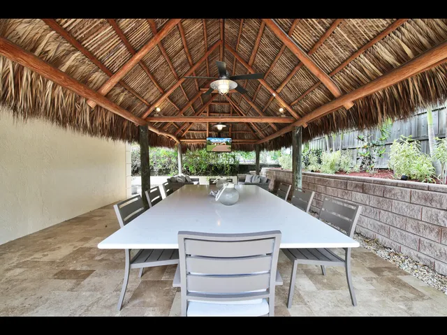 a view of a patio with table and chairs with wooden floor
