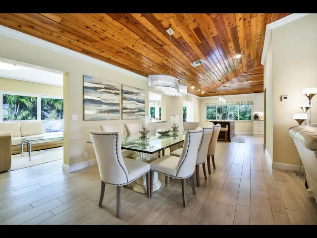 a dining room with furniture and wooden floor