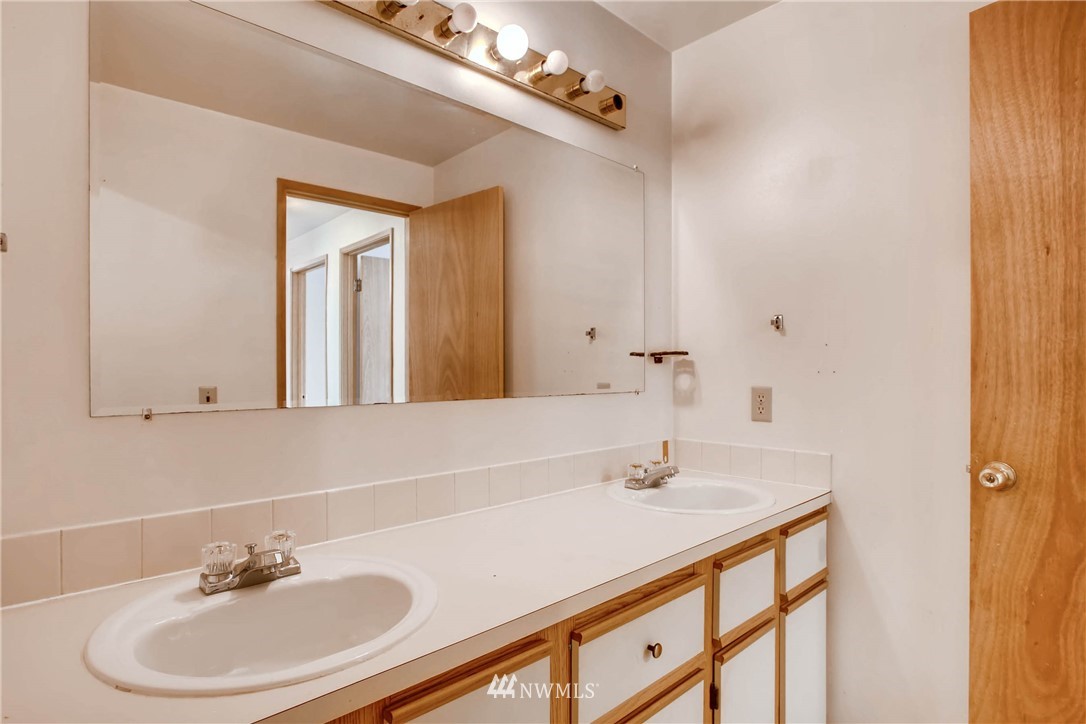 109 West Winesap Road Bothell, WA 98012 - Photo 14 of 22 a bathroom with a sink and a mirror