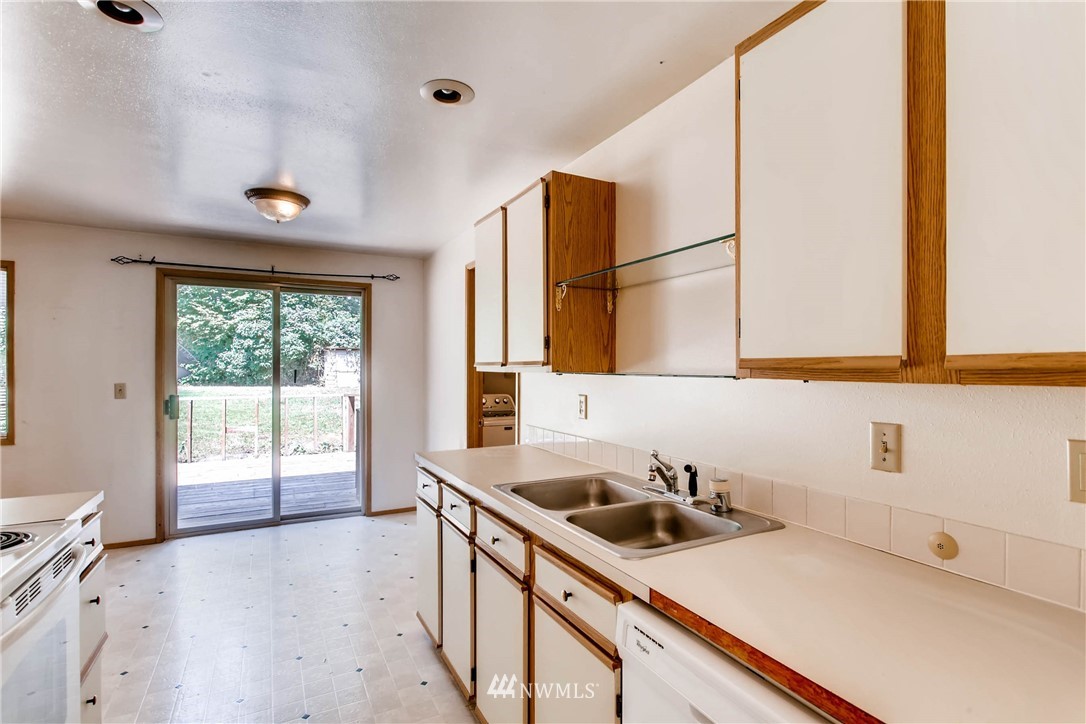 109 West Winesap Road Bothell, WA 98012 - Photo 7 of 22 a kitchen with a sink cabinets and window