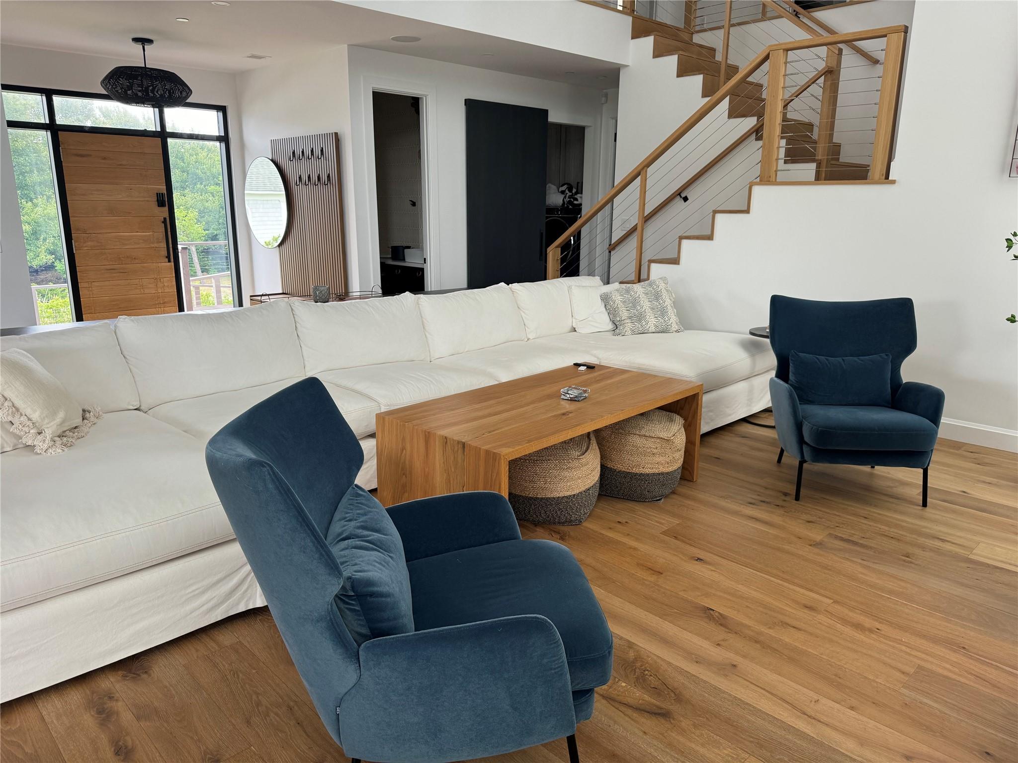 a living room with furniture rug and wooden floor