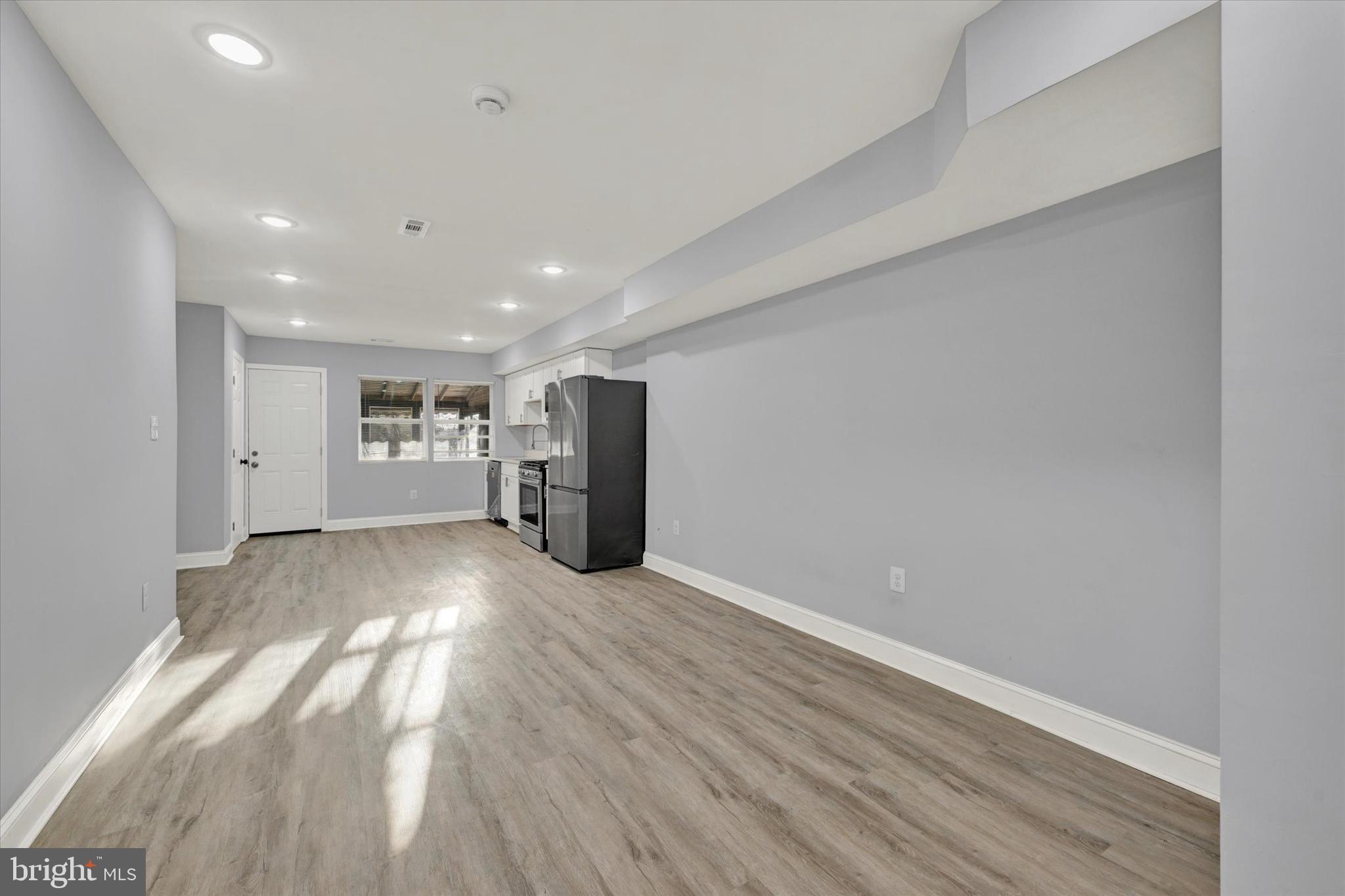 3105 Frisby Street Baltimore, MD 21218 - Photo 3 of 22 a view of an empty room with wooden floor