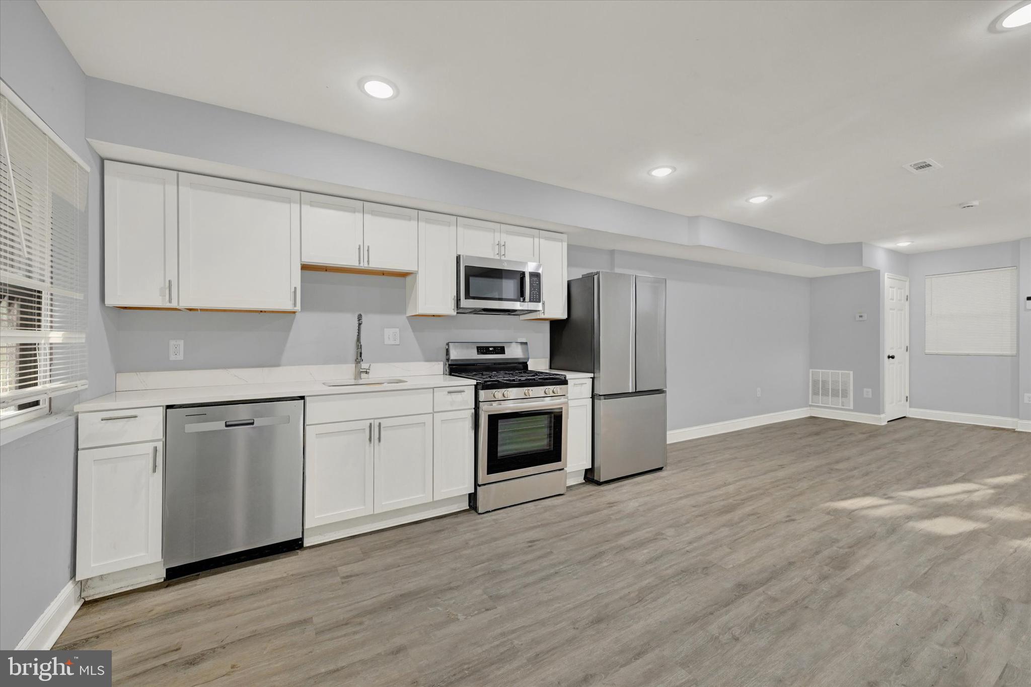 3105 Frisby Street Baltimore, MD 21218 - Photo 9 of 22 a kitchen with granite countertop a stove top oven and cabinets