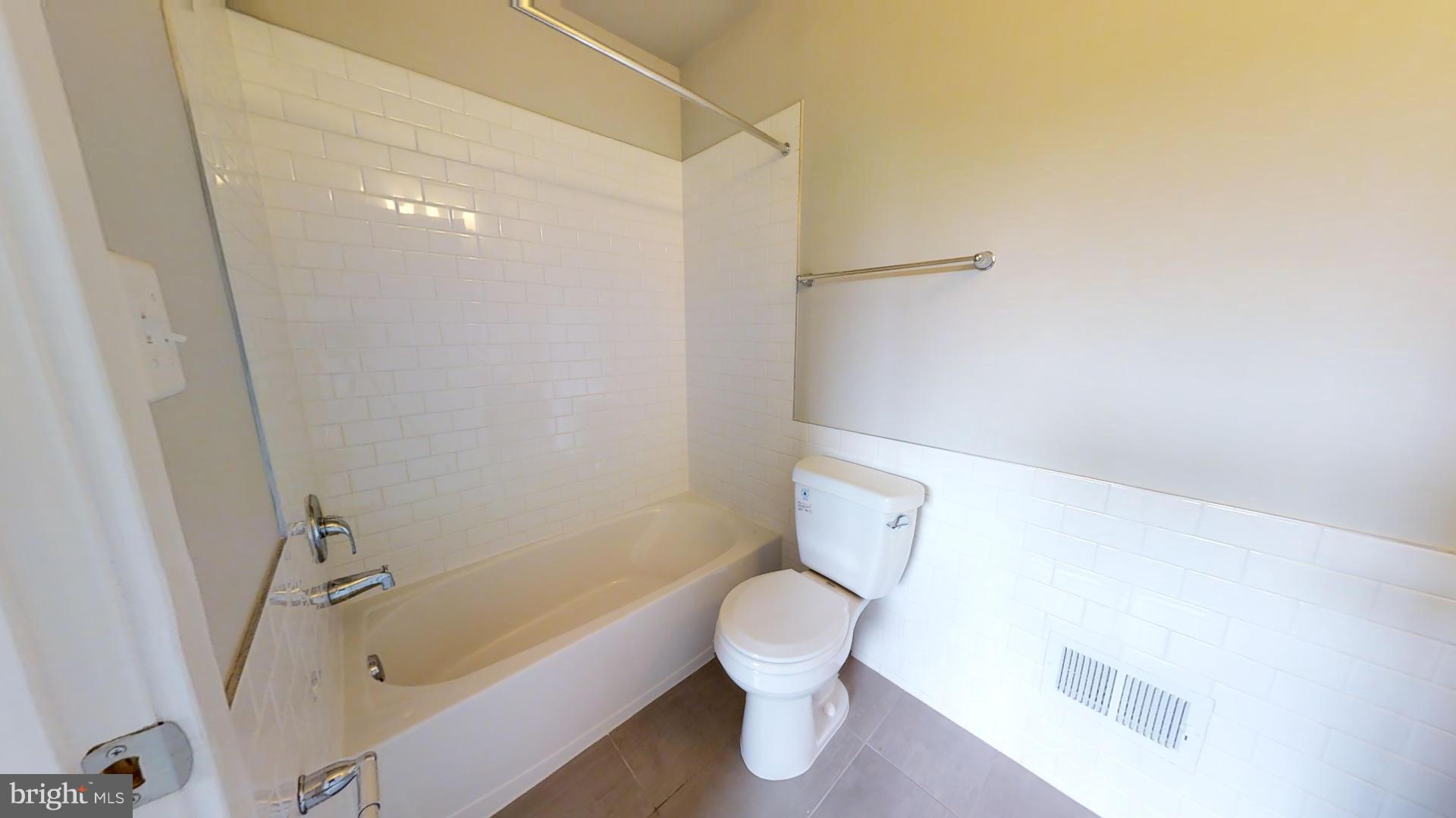 1262 Talbert Street Southeast, Unit A Washington, DC 20020 - Photo 11 of 20 a white toilet sitting next to a bath tub