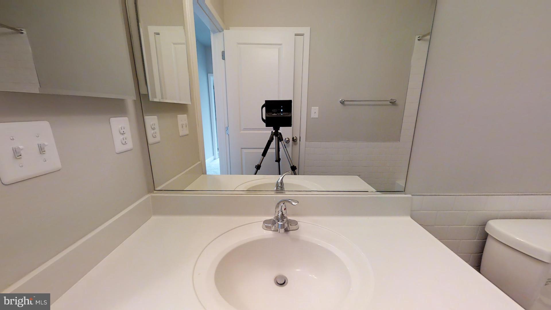 1262 Talbert Street Southeast, Unit A Washington, DC 20020 - Photo 16 of 20 a bathroom with a sink and a mirror