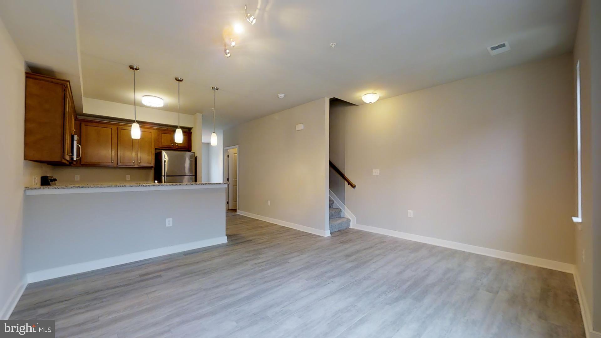 1262 Talbert Street Southeast, Unit A Washington, DC 20020 - Photo 4 of 20 a view of a big room with wooden floor and a sink