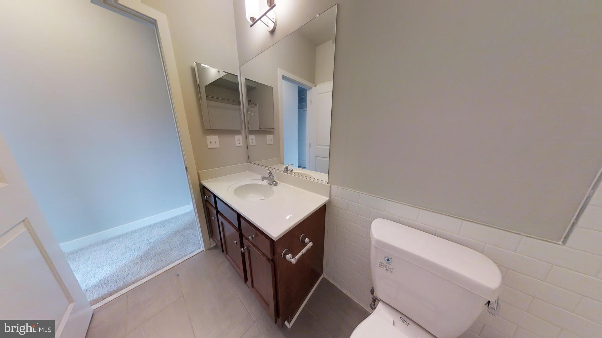 1262 Talbert Street Southeast, Unit A Washington, DC 20020 - Photo 6 of 20 a bathroom with a sink a toilet and mirror