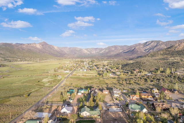 48 South Sage Road Pine Valley, UT 84781 - Photo 9 of 61 Aerial perspective showcasing a residential area nestled within a expansive valley, framed by prominent mountains