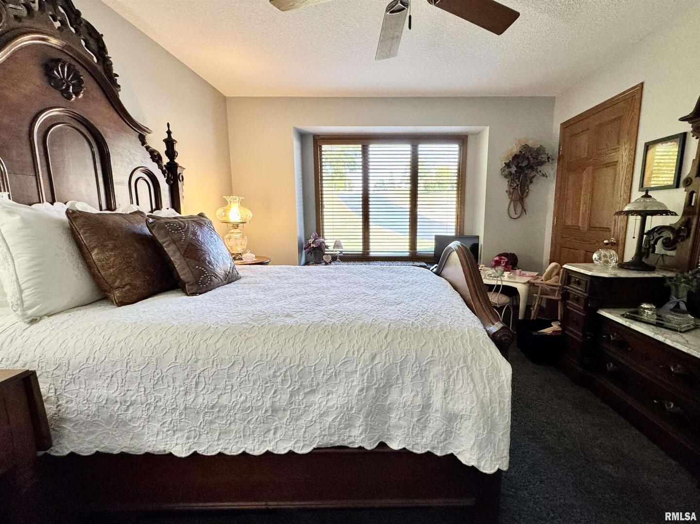 102 5th Street, Unit 6 Fulton, IL 61252 - Photo 23 of 42 a bedroom with a large bed and a flat tv screen on dresser