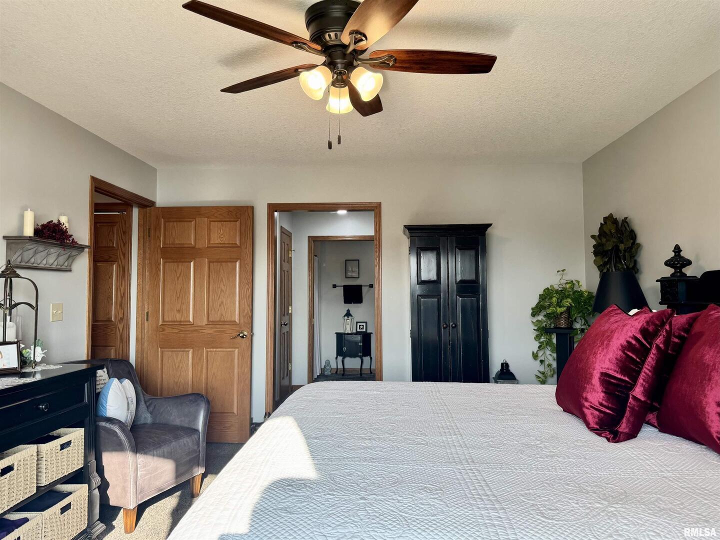 102 5th Street, Unit 6 Fulton, IL 61252 - Photo 25 of 42 a bedroom with a bed and a chandelier