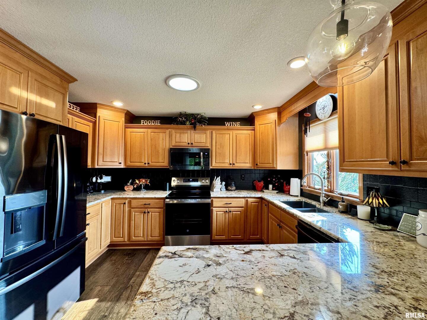 102 5th Street, Unit 6 Fulton, IL 61252 - Photo 3 of 42 a kitchen with stainless steel appliances granite countertop a sink stove and refrigerator