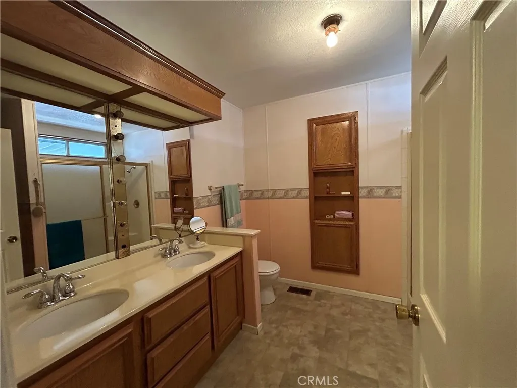 27250 Murrieta Road, Unit 347 Menifee, CA 92586 - Photo 18 of 38 a bathroom with a sink a toilet and shower