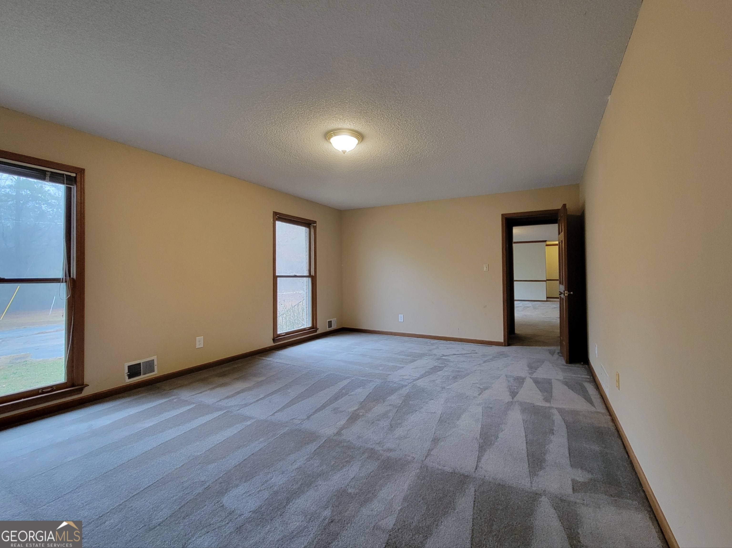 788 Harrison Mill Road Winder, GA 30680 - Photo 15 of 19 an empty room with wooden floor and windows