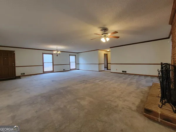 a view of entryway and hall with a ceiling fan