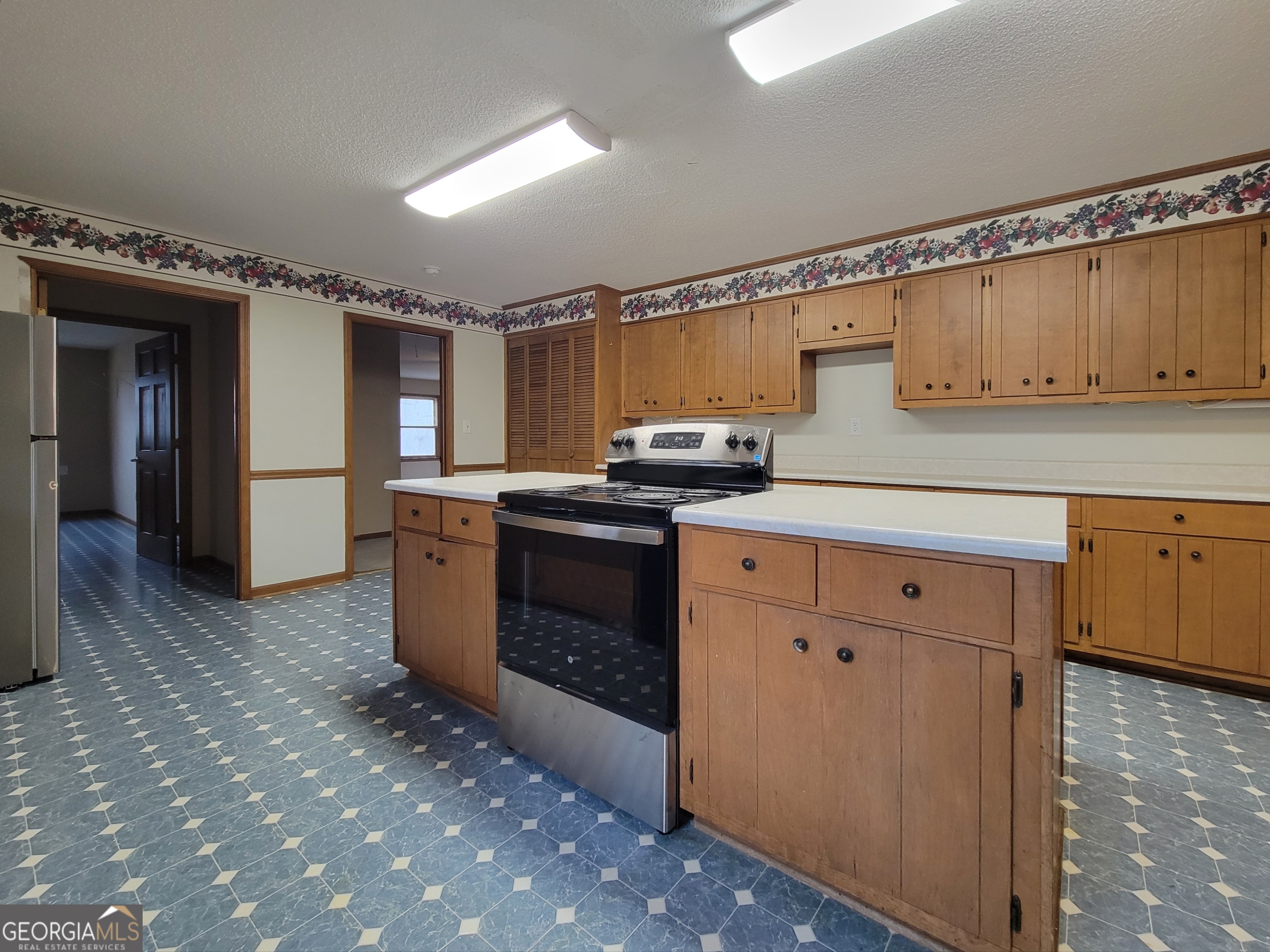 788 Harrison Mill Road Winder, GA 30680 - Photo 5 of 19 a kitchen with stainless steel appliances granite countertop a stove a sink and a refrigerator