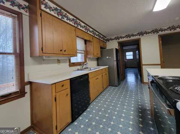 a kitchen with a sink appliances and cabinets
