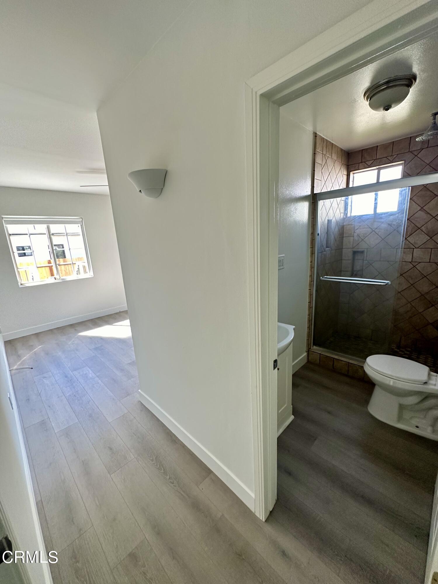 1811 Kenneth Way Pasadena, CA 91103 - Photo 14 of 20 an empty room with wooden floor and windows