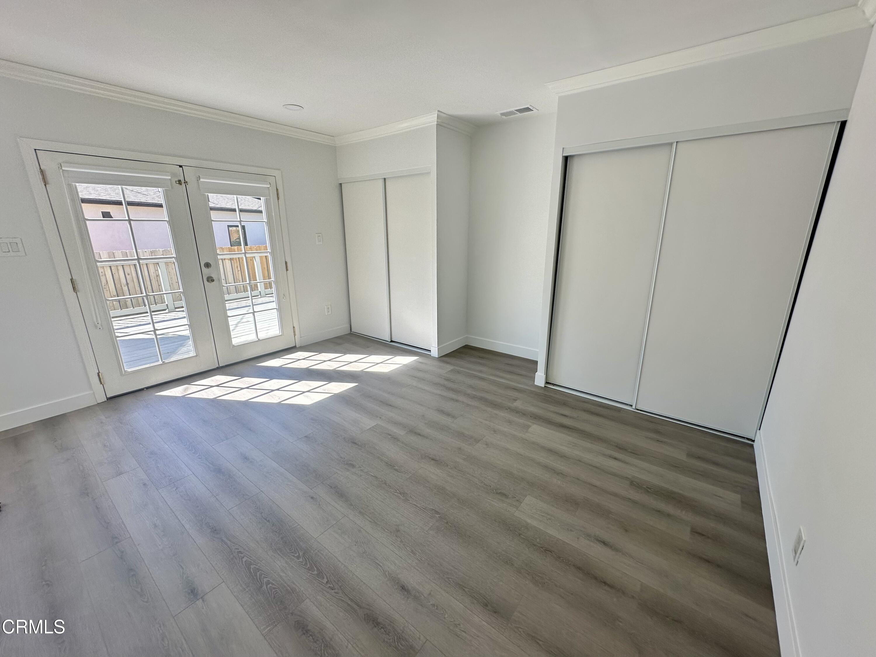 1811 Kenneth Way Pasadena, CA 91103 - Photo 17 of 20 a view of an empty room with wooden floor and a window