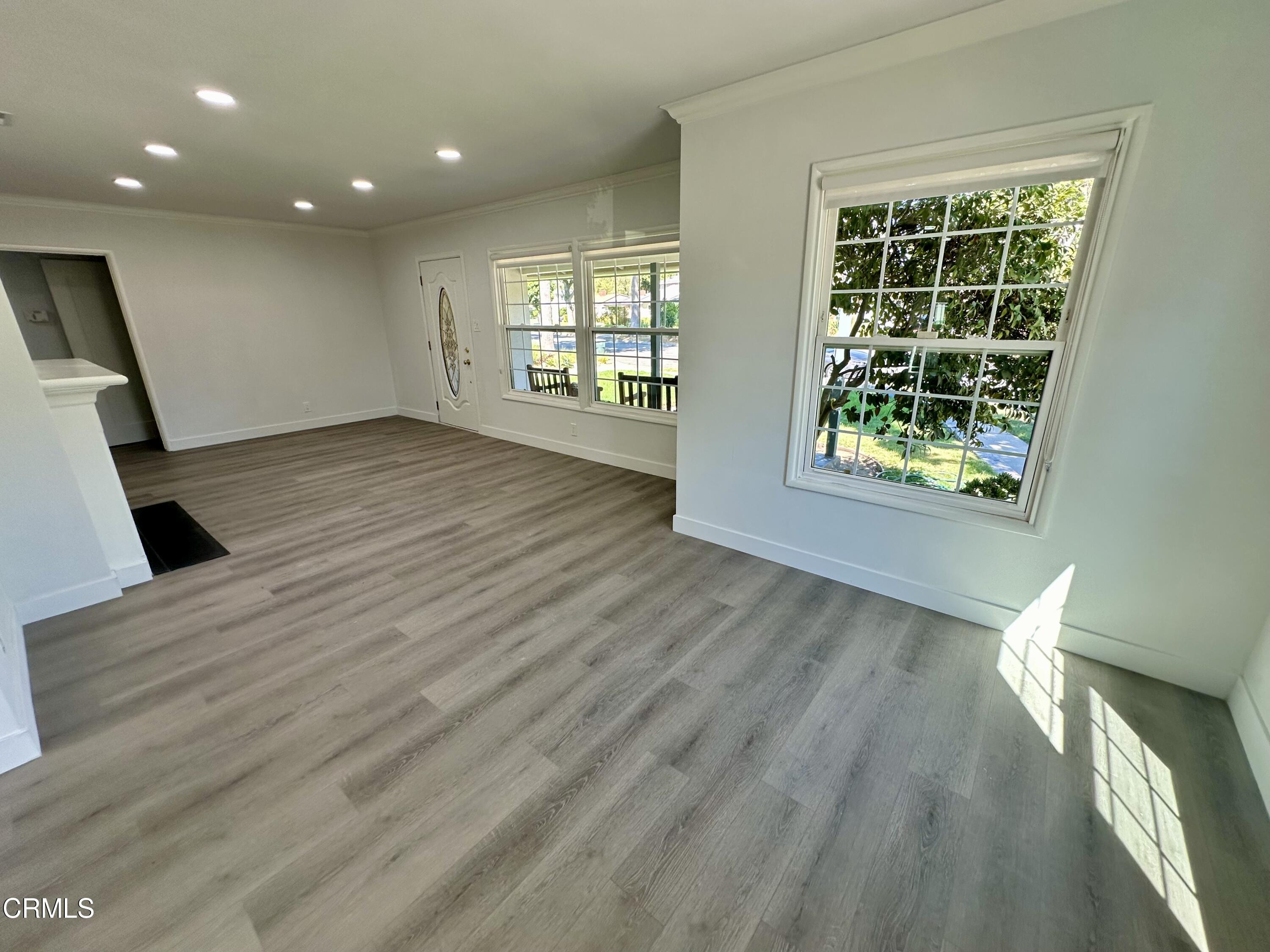 1811 Kenneth Way Pasadena, CA 91103 - Photo 3 of 20 an empty room with wooden floor and windows