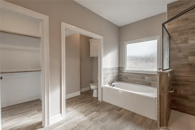 a white bath tub sitting next to a tub