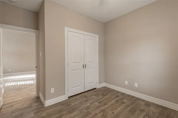 a view of an empty room and wooden floor