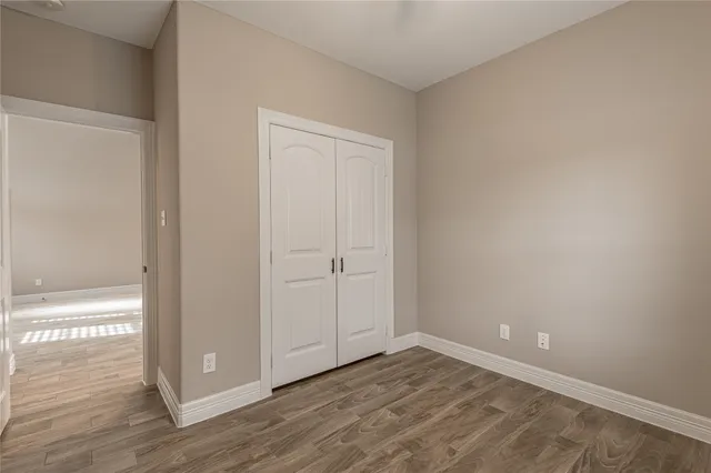 a view of an empty room and wooden floor