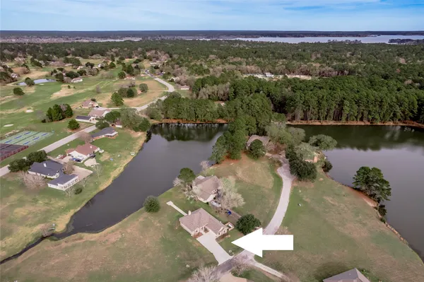 an aerial view of a house with a lake view