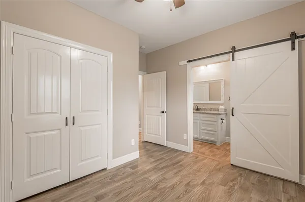 a view of empty room with wooden floor and cabinet