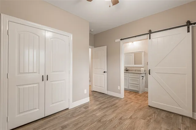 a view of empty room with wooden floor and cabinet