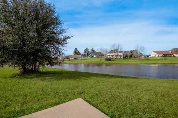 a view of a lake with houses in the background