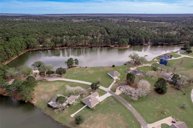 an aerial view of a house with a lake view