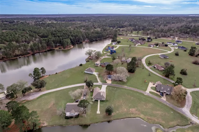 an aerial view of a house with a lake view