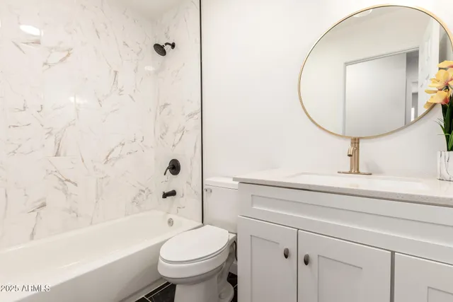 a bathroom with a sink a toilet and a mirror