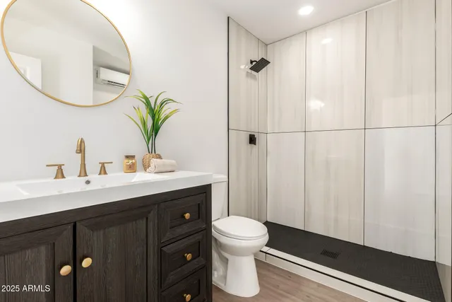 a bathroom with a toilet a sink and mirror