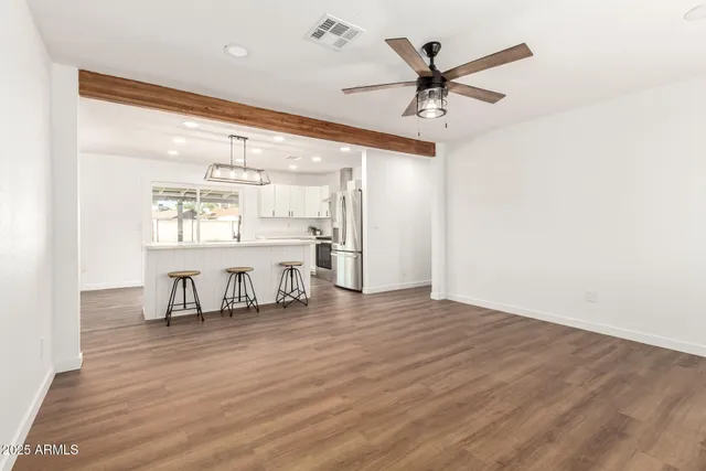 a view of work room with wooden floor and a ceiling fan