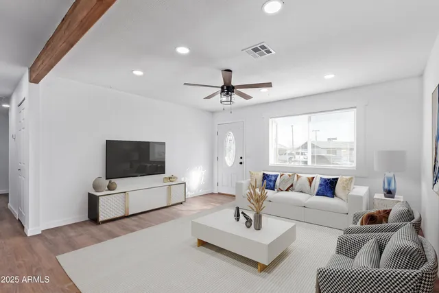 a living room with furniture and a flat screen tv
