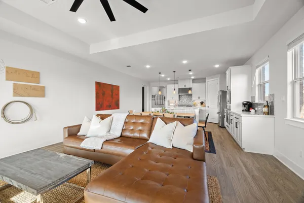 a living room with furniture and kitchen view
