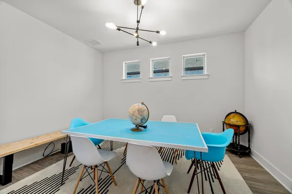 a view of a dining room with furniture and wooden floor