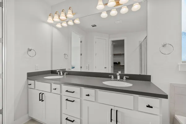 a bathroom with a granite countertop sink a large mirror and vanity