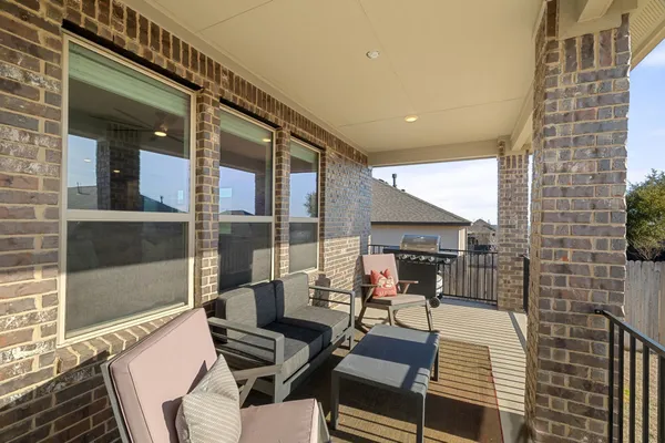 a balcony with furniture and a potted plant