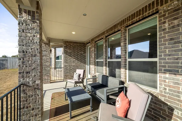 a balcony with furniture and wooden floor