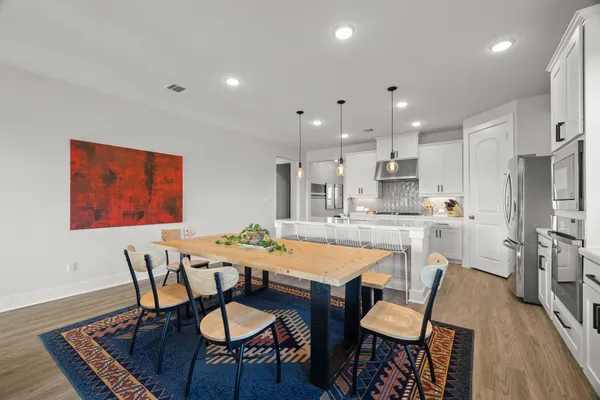 a view of a dining room with furniture and wooden floor