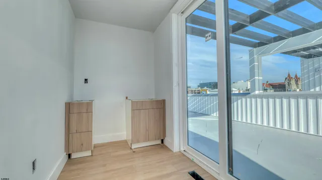 a view of a hallway to a livingroom with furniture
