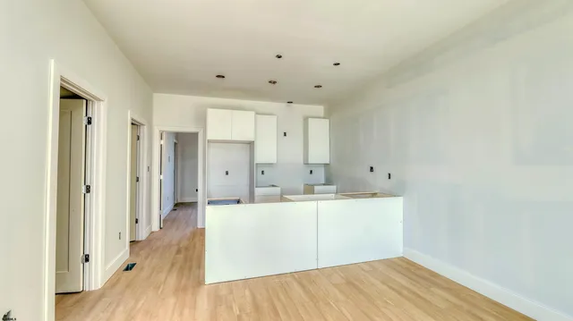 a view of a kitchen with wooden floor